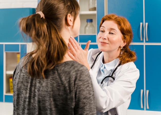 Young female doctor checking the patient