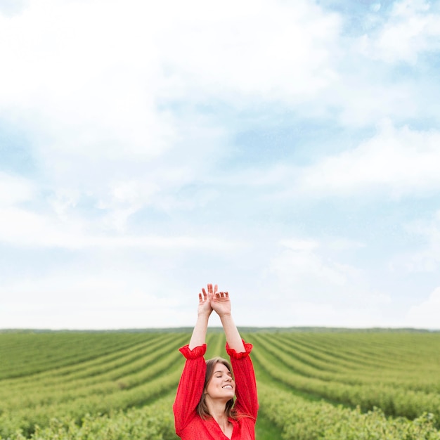 Young female in dress walking in field