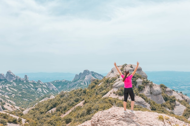 Free Photo young female enjoying the beautiful mountainous landscape in catalonia, spain