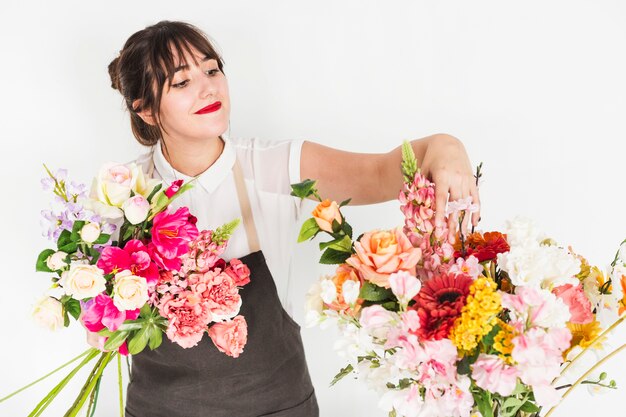 Young female florist sorting flowers