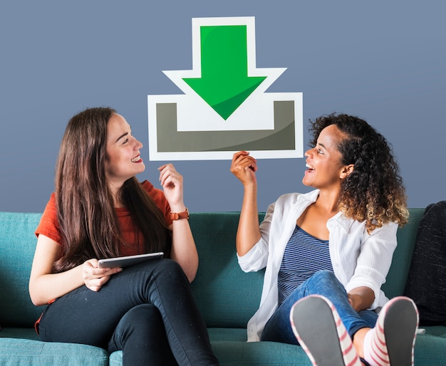 Free Photo young female friends holding a download icon