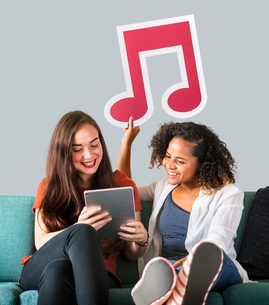 Young female friends holding a musical note icon