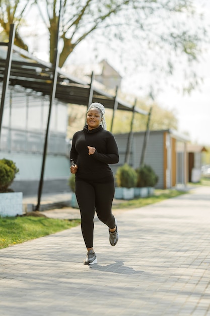 Free photo young female having fun training outdoor. sporty people lifestyle concept. woman in sportswear jogging