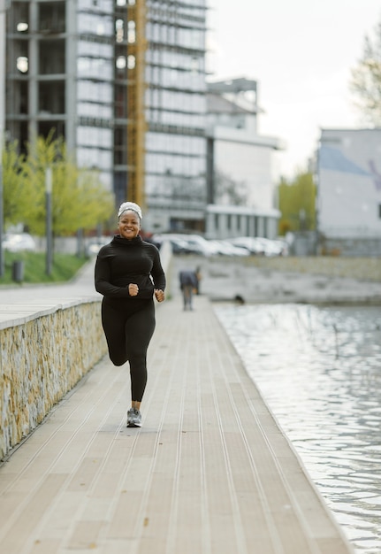 Free photo young female having fun training outdoor. sporty people lifestyle concept. woman in sportswear jogging