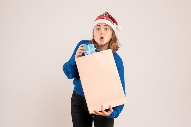 young female holding little present on white