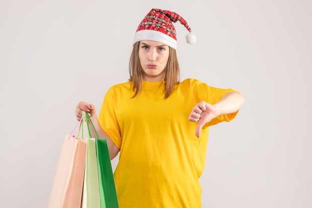 young female holding packages after shopping on white