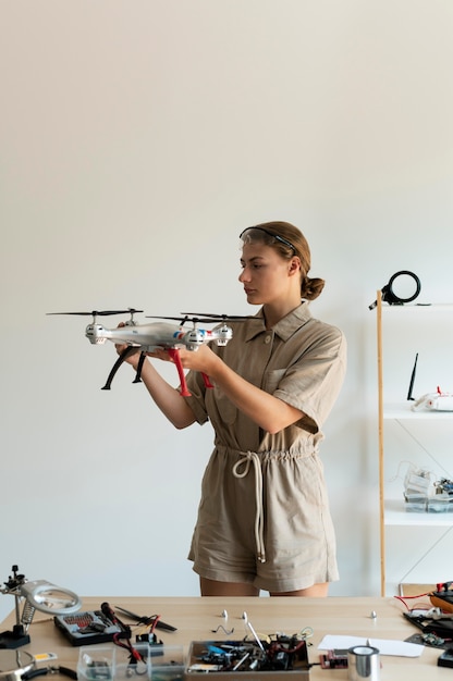 Free Photo young female inventor in her workshop