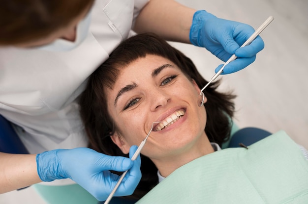 Young female patient having dental procedure at the orthodontist