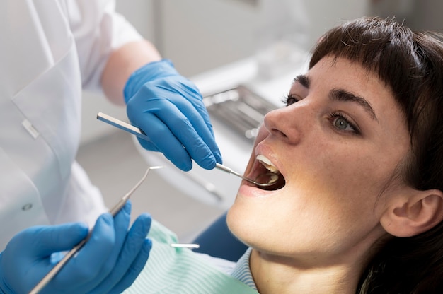 Free photo young female patient having dental procedure at the orthodontist