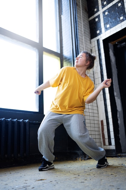 Free Photo young female performer dancing in an abandoned building