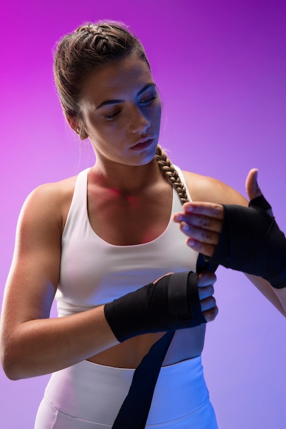 Young female practicing kickboxing