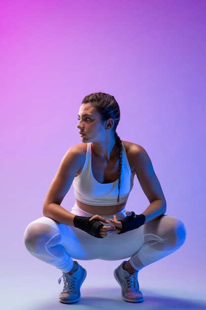 Young female practicing kickboxing