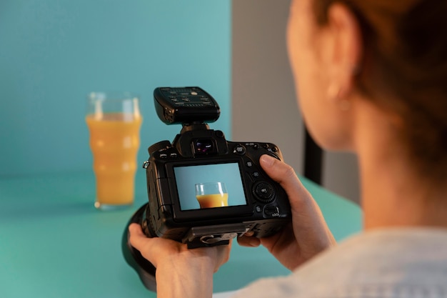 Young female product photographer in studio