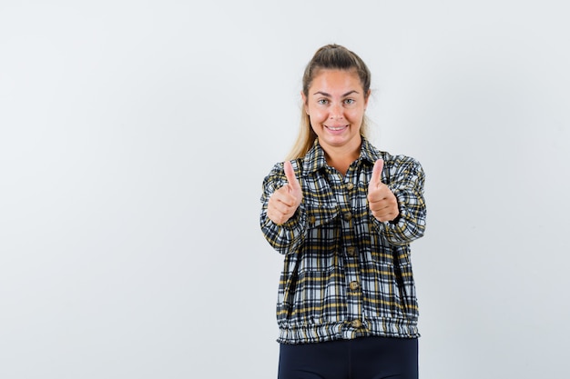 Free photo young female in shirt, shorts showing double thumbs up and looking confident , front view.