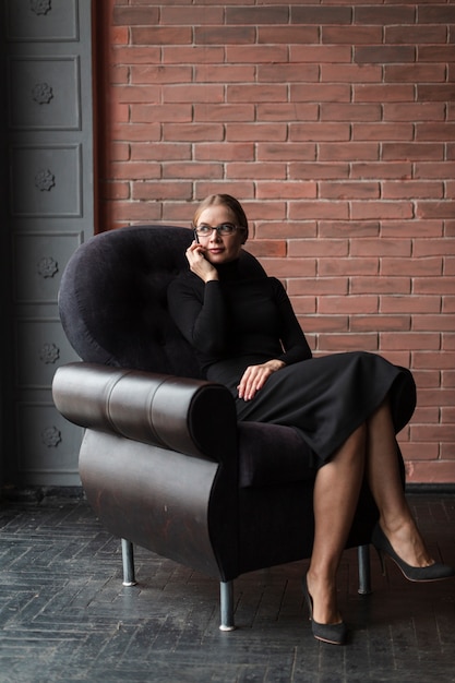 Free Photo young female sitting on couch