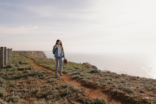 Free photo young female traveler enjoying the peace around her