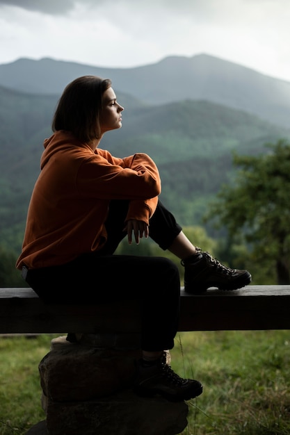 Young female traveler enjoying rural surroundings