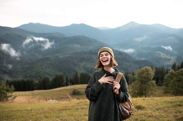 Young female traveler enjoying rural surroundings