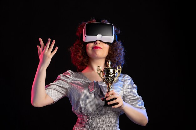 Young female wearing vr headset with cup on dark  video gaming vision play