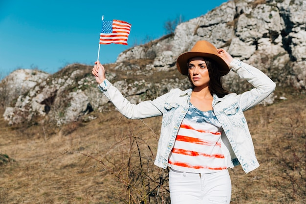 Free photo young female with american flag in nature