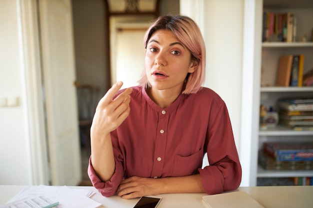 Young female with pinkish hair posing