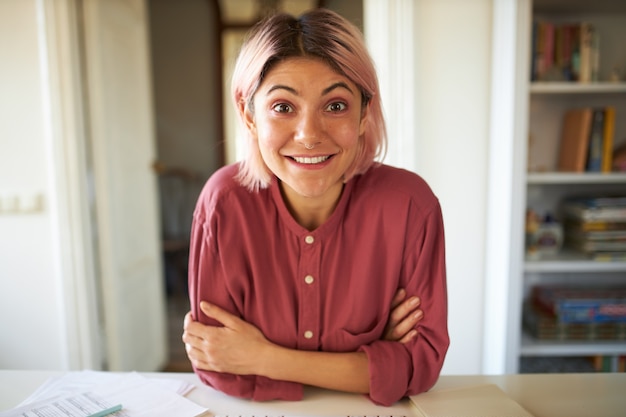 Young female with pinkish hair posing