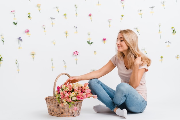 Young female with tulips in basket