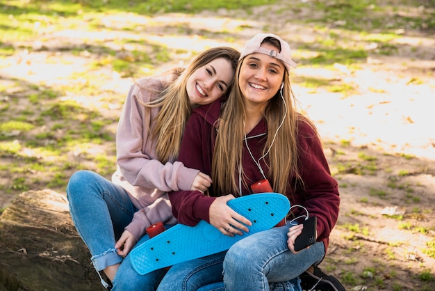 Free photo young females sitting outdoors