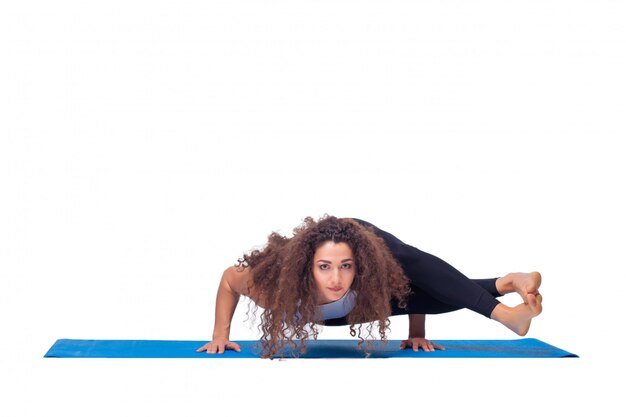 young fit woman doing yoga exercises.