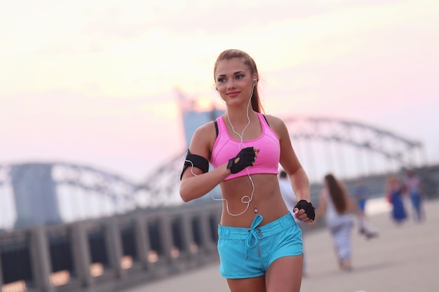 Young fit woman in sportswear outdoors