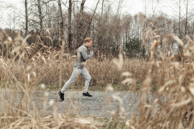 Free Photo young fitness male athlete running in the farm