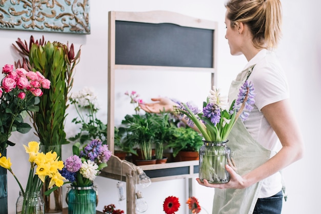 Young florist taking care of flowers