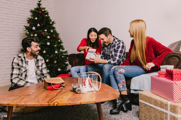 Young friends gifting each other