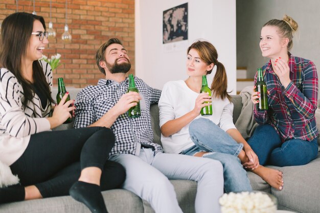 Young friends having beers and talking