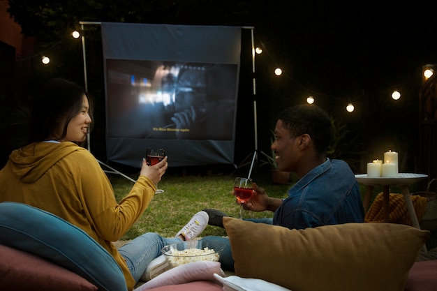 Young friends having fun at cinema in open air