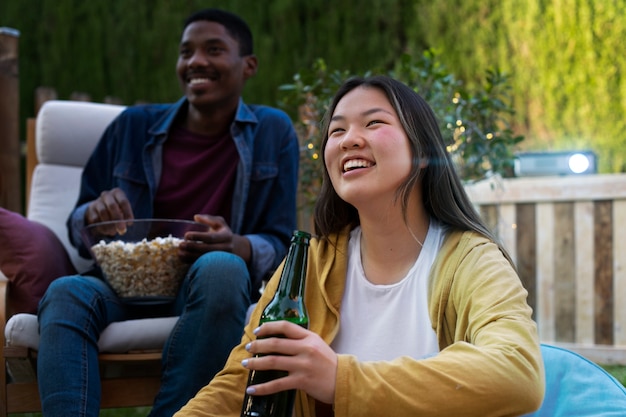 Young friends having fun at cinema in open air