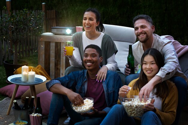 Young friends having fun at cinema in open air