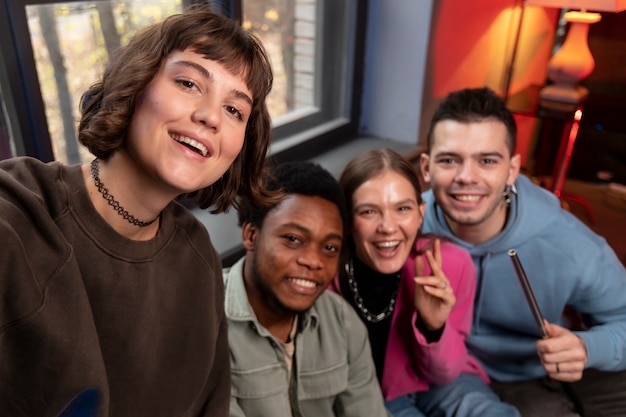 Young friends posing for a photo while enjoying a hookah