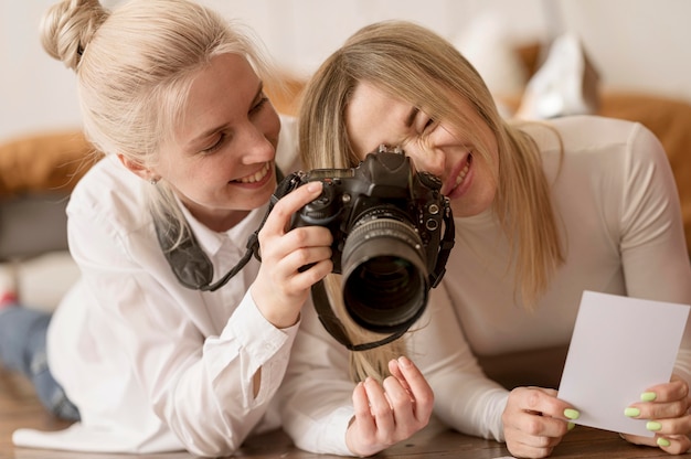 Young friends using a professional camera