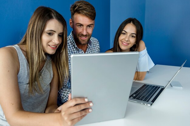 Young friends working with devices