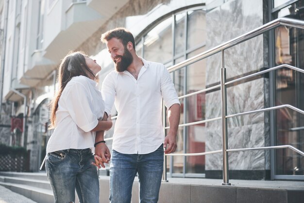 A young funny loving couple have fun on a sunny day.