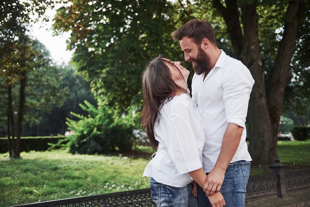 A young funny loving couple have fun on a sunny day.