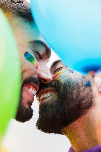 Free Photo young gays smiling while kissing