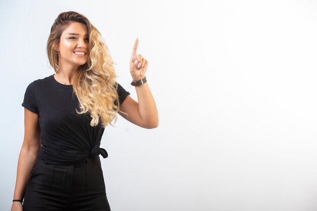 Young girl in black sport outfits feels positive.