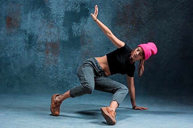 Young girl break dancing on wall 