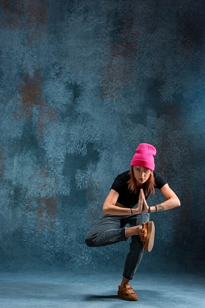 Young girl break dancing on wall 