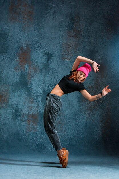 Young girl break dancing on wall 