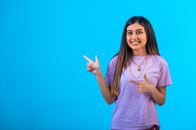 Young girl doing pointing sign.