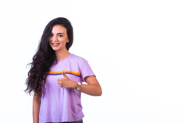 Young girl doing positive hand sign .