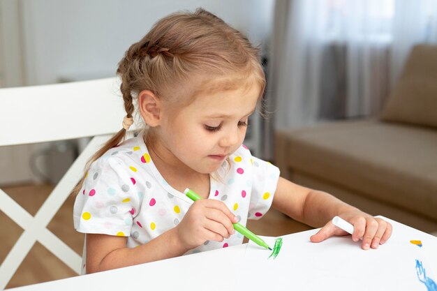 Young girl drawing at home